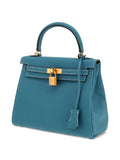 Hermès 2023 Kelly 25 blue leather handbag with twist-lock and detachable strap, perfect for trendy outfits in 2025.